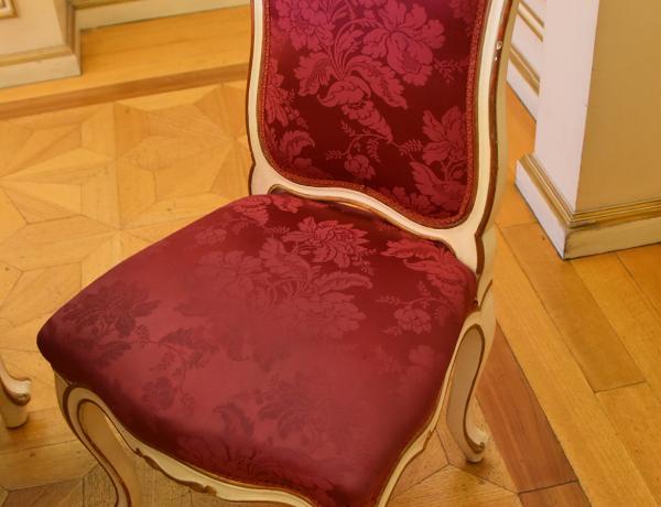 Red velvet upholstered chair.
